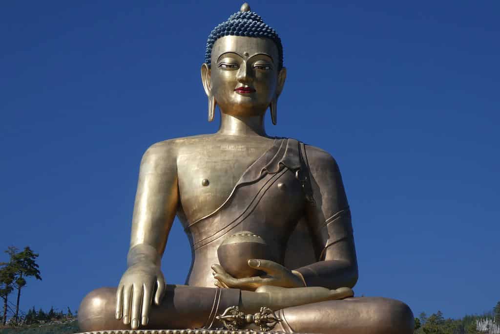 Impressive view of the giant Buddha Dordenma statue overlooking Thimphu Valley, surrounded by misty mountains.