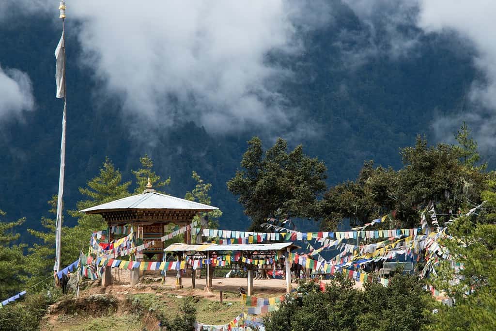 Majestic view of Trashichhoe Dzong, showcasing its intricate architecture and stunning riverside location.