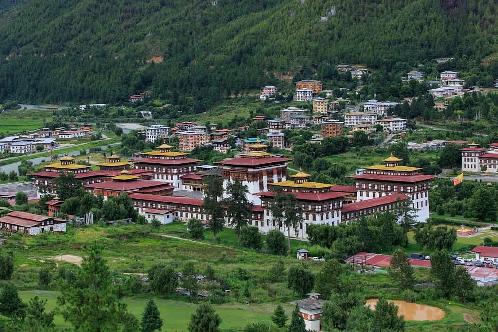 Bustling street scene with colorful market stalls and traditional Bhutanese architecture in Thimphu.