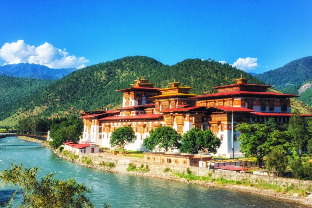 Majestic view of Trashichhoe Dzong, showcasing its intricate architecture and stunning riverside location.